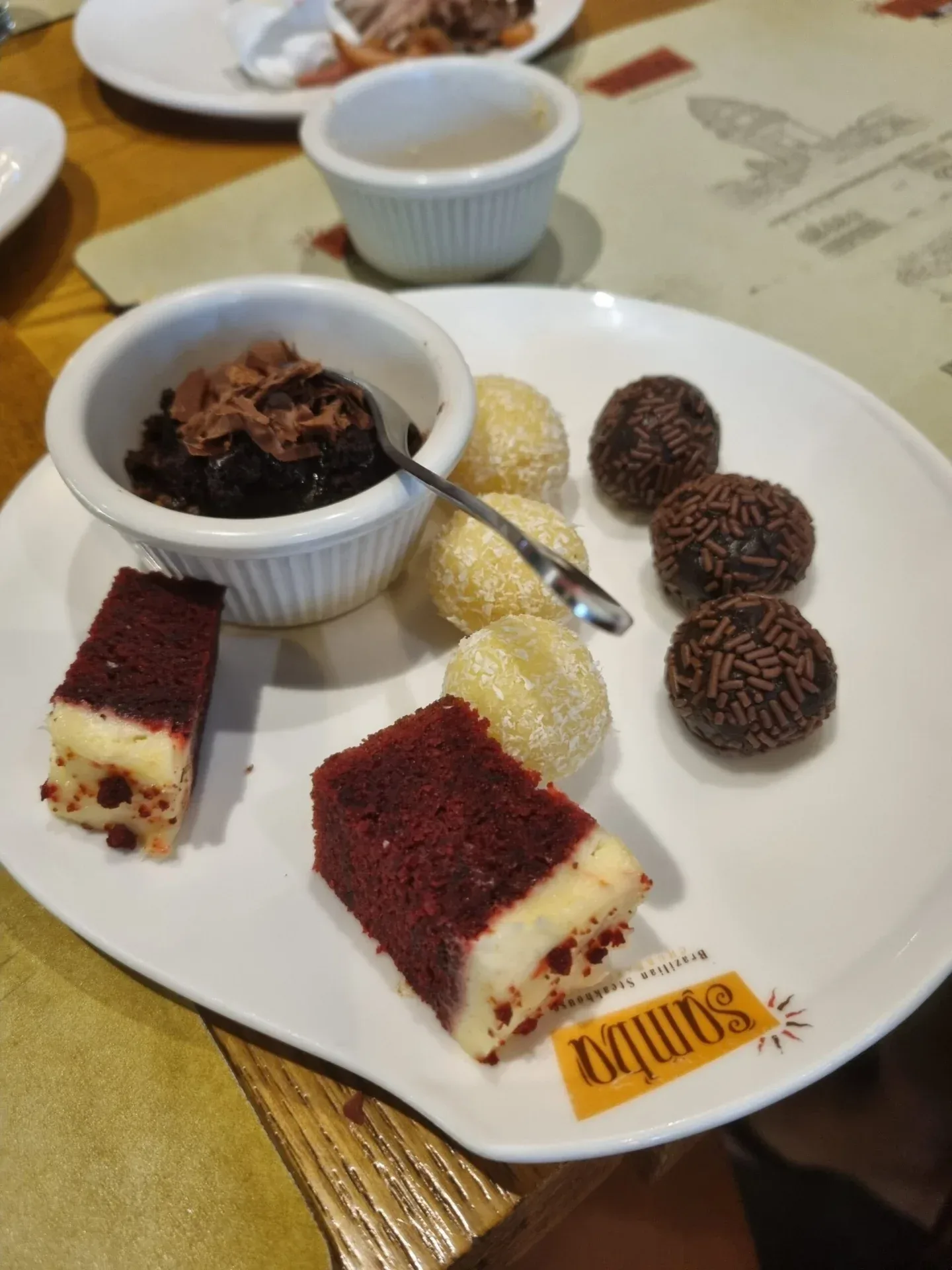 Plate of Brazilian sweets and small desserts on a table.